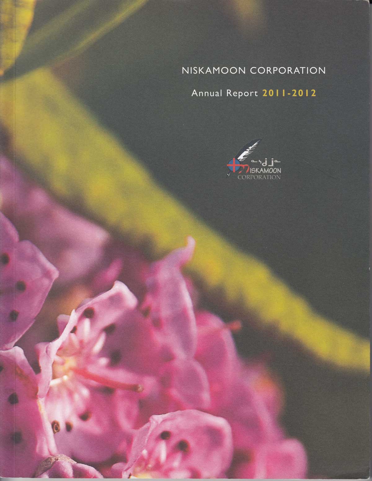 Cover of the Annual Report 2011-2012 for Niskamoon Corporation, featuring close-up pink flowers, blurred green leaves, and the Niskamoon Corporation logo with text in English and Cree.